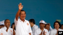 Cambodian Prime Minister Hun Sen waves to supporters during his Cambodian People's Party's campaign in Phnom Penh, Cambodia, Saturday, July 7, 2018. (AP Photo/Heng Sinith)