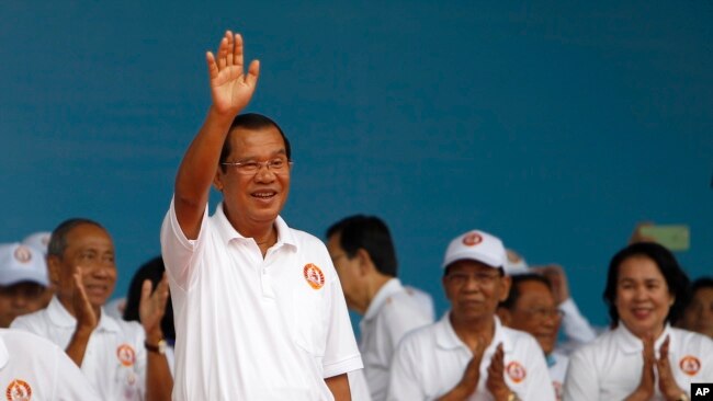 Cambodian Prime Minister Hun Sen waves to supporters during his Cambodian People's Party's campaign in Phnom Penh, Cambodia, Saturday, July 7, 2018. (AP Photo/Heng Sinith)