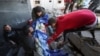 Palestinians carry the dead body of a child, at the site of an Israeli strike on a house in Nuseirat, in the central Gaza Strip, Jan. 9, 2025, amid the ongoing conflict between Israel and Hamas.