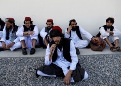 FILE - Newly freed Taliban prisoners sit at Pul-i-Charkhi prison, in Kabul, Afghanistan, May 26, 2020.