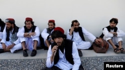 FILE - Newly freed Taliban prisoners sit at Pul-i-Charkhi prison, in Kabul, Afghanistan, May 26, 2020. 