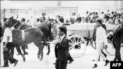 FILE - (FILES) Two mules pull a cart carrying the coffin of the US clergyman, leader of the Movement against Racial Segregation and Nobel Peace Prize winner Martin Luther King during his funeral, 9 April 1968, in Atlanta.