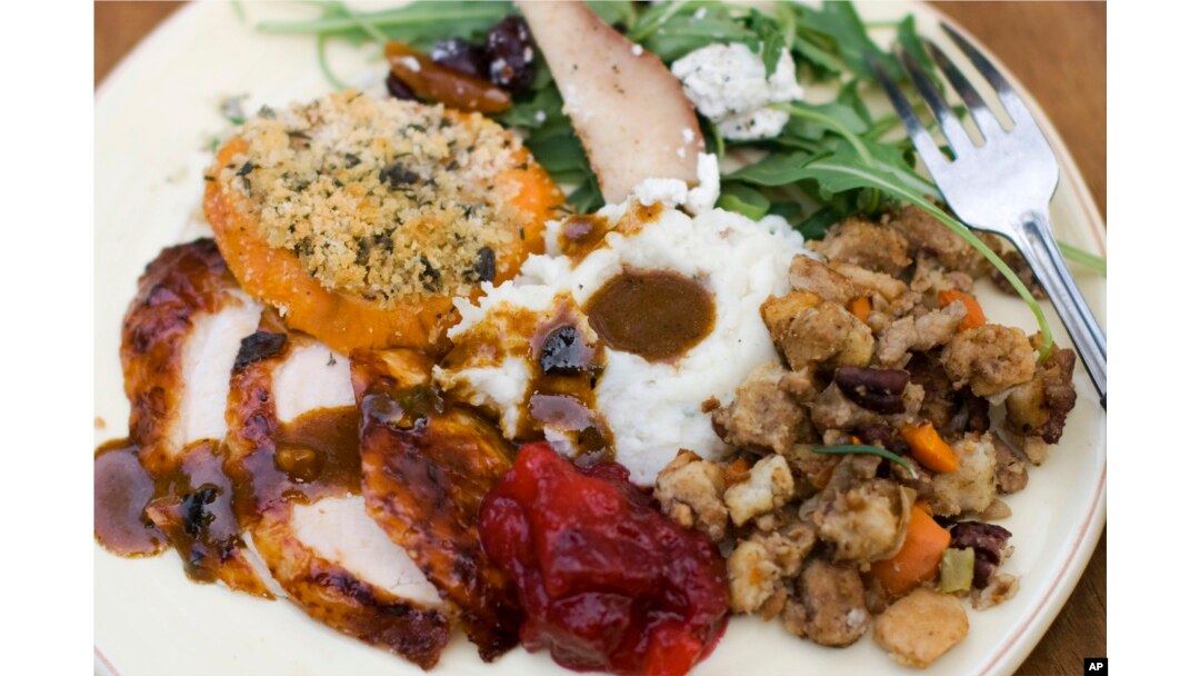 FILE — A traditional Thanksgiving dinner often includes turkey, gravy, cranberry sauce, mashed potatoes, stuffing and sweet potatoes.