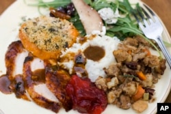 FILE — A traditional Thanksgiving dinner often includes turkey, gravy, cranberry sauce, mashed potatoes, stuffing and sweet potatoes.