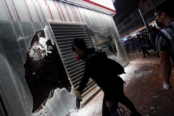 Anti-government protesters vandalize Bank of China branch during a protest in Tsuen Wan in Hong Kong, Oct. 13, 2019.