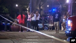 This image provided by WBMA shows bystanders near the scene of a mass shooting in Birmingham, Alabama, Sept. 22, 2024.