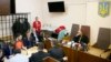 The head of Ukraine's tax and customs service Roman Nasirov (in orange shirt), who is under investigation over the suspected embezzlement of $75 million, attends a court hearing in Kyiv, Ukraine, March 6, 2017.