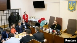 The head of Ukraine's tax and customs service Roman Nasirov (in orange shirt), who is under investigation over the suspected embezzlement of $75 million, attends a court hearing in Kyiv, Ukraine, March 6, 2017.