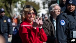 Actress Jane Fonda gestures after being arrested during a rally on Capitol Hill in Washington, Oct. 18, 2019.