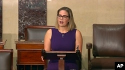 FILE - In this image from Senate Television, Sen. Kyrsten Sinema, D-Ariz., speaks on the floor of the U.S. Senate, Jan. 13, 2022.