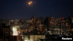 FILE - An explosion is seen in the sky during a Russian drone strike in Kyiv, Ukraine, Oct. 17, 2024. Ukraine's military deployed air-defense systems late Saturday to repel an aerial assault on Kyiv, according to the capital's top elected official.   