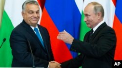 PM Hungaria Viktor Orban (kiri) berjabat tangan dengan Presiden Rusia Vladimir Putin usai pembicaraan di Kremlin, Selasa (18/9). 