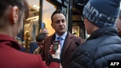 Ireland's Prime Minister and leader of the Fine Gael party, Leo Varadkar, center, talks with a young man about Brexit as he canvasses for support in Ennis, County Clare, Ireland, Feb. 7, 2020, ahead of Saturday's General Election. 