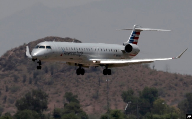 FILE - An American Eagle jet lands at Sky Harbor International Airport, in Phoenix, June 19, 2017.