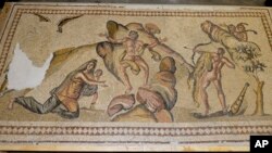 This undated photo provided by the U.S Department of Justice shows an ancient mosaic believed to have been looted from war-torn Syria and illegally imported into the United States. 