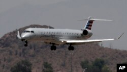 An American Eagle jet is seen through heat ripples as it lands at Sky Harbor International Airport, Monday, June 19, 2017 ,in Phoenix. American Airlines cancelled dozens flights out of Phoenix today due to extreme heat. 