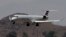 An American Eagle jet is seen through heat ripples as it lands at Sky Harbor International Airport, Monday, June 19, 2017 ,in Phoenix. American Airlines cancelled dozens flights out of Phoenix today due to extreme heat. 