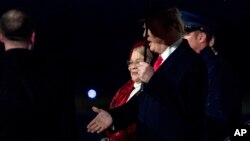 President Donald Trump accompanied by Dr. Alveda King, niece of civil rights activist Dr. Martin Luther King Jr., center, arrives at Dobbins Air Reserve Base in Marietta, Georiga, Jan. 8, 2018, 