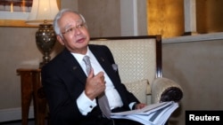 FILE - Malaysia's Prime Minister Najib Razak speaks to Reuters during the 10th World Islamic Economic Forum in Dubai Oct. 28, 2014.
