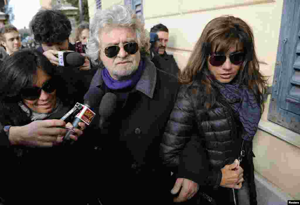 Five Star Movement leader and comedian Beppe Grillo and his wife Parvin Tadjik arrive to cast their votes in Genoa, Italy, Feb. 25, 2013.