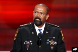 FILE - David Clarke, Sheriff of Milwaukee County, Wisconsin, speaks during the opening day of the Republican National Convention in Cleveland, July 18, 2016.
