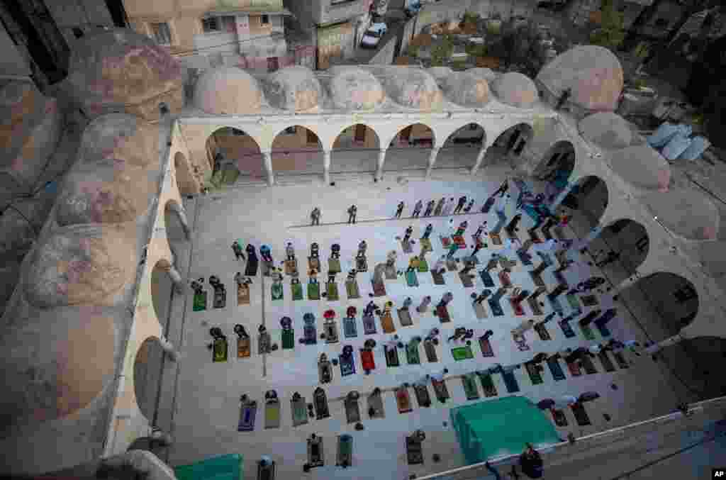 Muslims wearing face masks attend the Eid al-Fitr prayers outside a mosque in Gaza City, May 24, 2020.