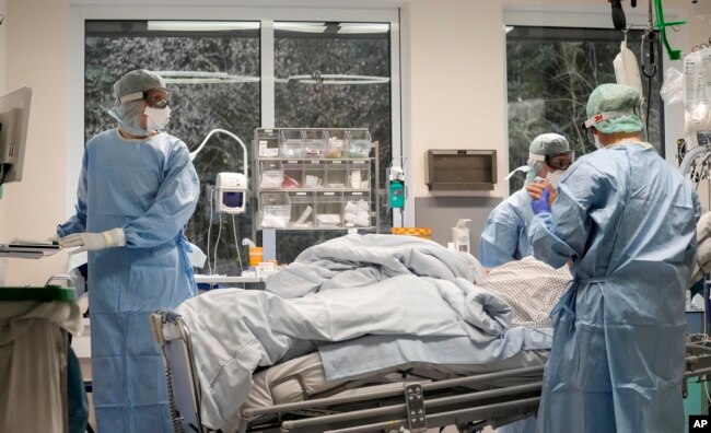 An intubated COVID-19 patient gets treatment at the intensive care unit at the Westerstede Clinical Center, a military-civilian hospital in Westerstede, northwest Germany, Dec. 17, 2021.