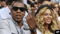 Rapper Jay-Z and his wife, singer Beyonce, attend the match between Novak Djokovic of Serbia and Rafael Nadal of Spain during the men's final of the U.S. Open tennis tournament in New York (file photo)