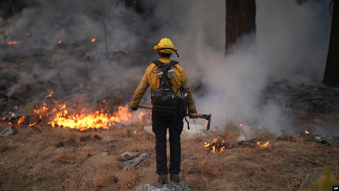 A firefighter works to contain the Bridge Fire in Wrightwood, California, Sept. 11, 2024.