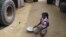 A girl gathers rice spilled from a humanitarian food convoy in the northeastern city of Gao, Mali, June 14, 2012.