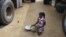 A girl gathers rice spilled from a humanitarian food convoy in the northeastern city of Gao, Mali, June 14, 2012.