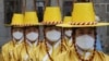 Imperial guards wear protective face masks during a reenactment of the Royal Guards Changing Ceremony in front of Deoksu Palace in Seoul, South Korea, Jan. 30, 2020.