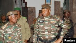 FILE - General Abdourahmane Tchiani, who was declared as the new head of state of Niger by leaders of a coup, arrives to meet with ministers in Niamey, Niger July 28, 2023.