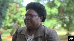 FILE: Zimbabwe's Vice President Joice Mujuru arrives at the Harare magistrates courts in Harare, Tuesday, Jan. 24, 2012, Mujuri testified in the long awaited inquest hearing into the mysterious death of her late husband Solomon Mujuru. Mujuru died in a mysterious fire at his farm in 2011.(AP Photo/Tsvangirayi Mukwazhi)