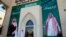FILE - Men walk past murals depicting Saudi Arabia's King Salman bin Abdulaziz Al Saud and Crown Prince Mohammed bin Salman, in Riyadh, Saudi Arabia, Nov. 9, 2017.