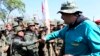 In this handout photo released by Miraflores Press Office, Venezuela's President Nicolas Maduro fist bumps with a cadet at the G/J José Laurencio Silva military training center in the state of Cojedes, Venezuela, May 4, 2019.