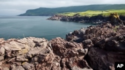 FILE - Lava sediment of the Bogdan Khmelnitsky Volcano is seen on Iturup Island, in the Russian Far East, Aug. 21, 2011. Iturup is one of the Kuril Islands, as Russia calls them. Japan refers to them as the Northern Territories. 