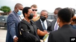 In this handout photo released by Haitian officials, Haiti's first lady, Martine Moise, her right arm in a sling, arrives at the Toussaint Louverture International Airport, in Port-au-Prince, July 17, 2021.