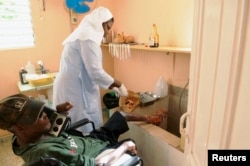 FILE - A nun tends to man with leprosy in the isolated village of Nigua, south of Santo Domingo, July 9, 2012.