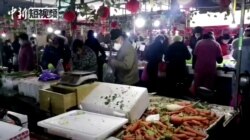 CHINA - People wearing masks shop at a market in Wuhan, Hubei province, 23 Jan, 2020