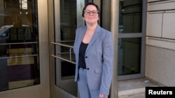 FILE - Cathy Harris of the U.S. Merit Systems Protection Board poses as she leaves the E. Barrett Prettyman U.S. Courthouse in downtown Washington, D.C., March 3, 2025.