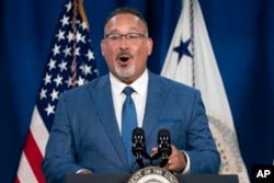 Education Secretary Miguel Cardona speaks at an event where Vice President Kamala Harris announced the cancelation of all federal student loans borrowed by students to attend any Corinthian Colleges, Thursday, June 2, 2022, at the Department of Education in Washington. (AP Photo/Jacquelyn Martin)