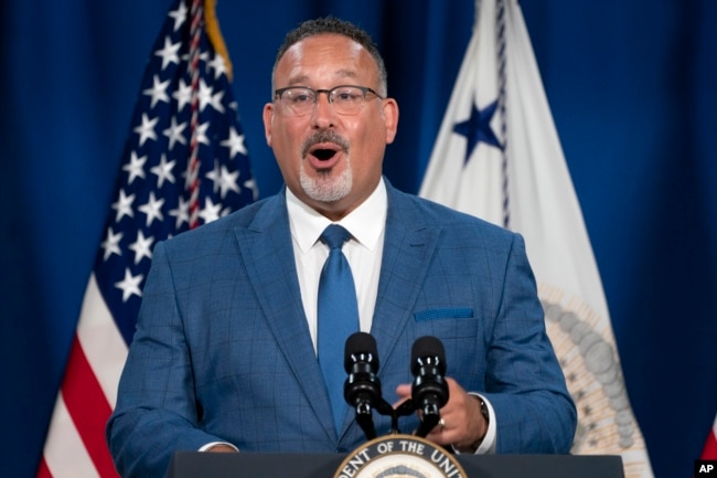 Education Secretary Miguel Cardona speaks at an event where Vice President Kamala Harris announced the cancelation of all federal student loans borrowed by students to attend any Corinthian Colleges, Thursday, June 2, 2022, at the Department of Education in Washington. (AP Photo/Jacquelyn Martin)