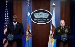 U.S. Defense Secretary Lloyd Austin and General Mark Milley, Chairman of the U.S. Joint Chiefs of Staff, face reporters asking questions about Russia and Ukraine during a news conference at the Pentagon in Washington, Jan. 28, 2022.