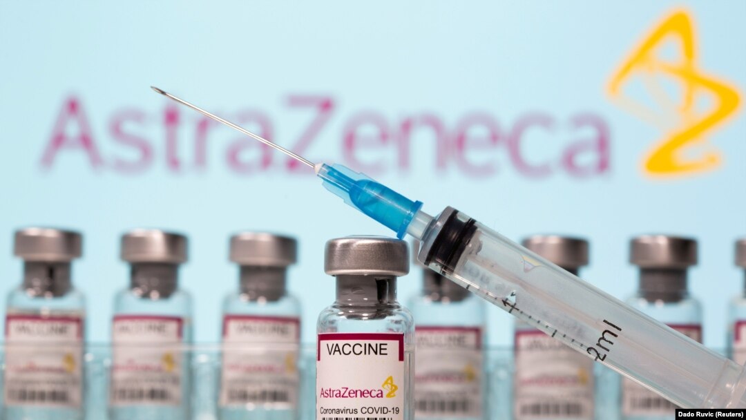 FILE PHOTO: Vials labeled "AstraZeneca COVID-19 Coronavirus Vaccine" and a syringe are seen in front of a displayed AstraZeneca logo in this illustration taken March 10, 2021.