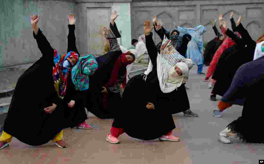 Women take part in yoga session in the historical Shalimar Garden in Lahore, Pakistan.