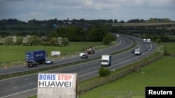 A sign reading "Boris Stop Huawei" is seen next to the M40 motorway, Tetsworth, Britain, May 1, 2020. 