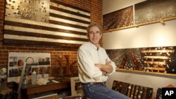 Thomas Sayre, the great grandson of U.S. President Woodrow Wilson, poses for a photograph in his studio near some of his artwork creations in Raleigh, North Carolina, December 1, 2015. Photo taken December 1, 2015.