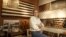 Thomas Sayre, the great grandson of U.S. President Woodrow Wilson, poses for a photograph in his studio near some of his artwork creations in Raleigh, North Carolina, December 1, 2015. Photo taken December 1, 2015.