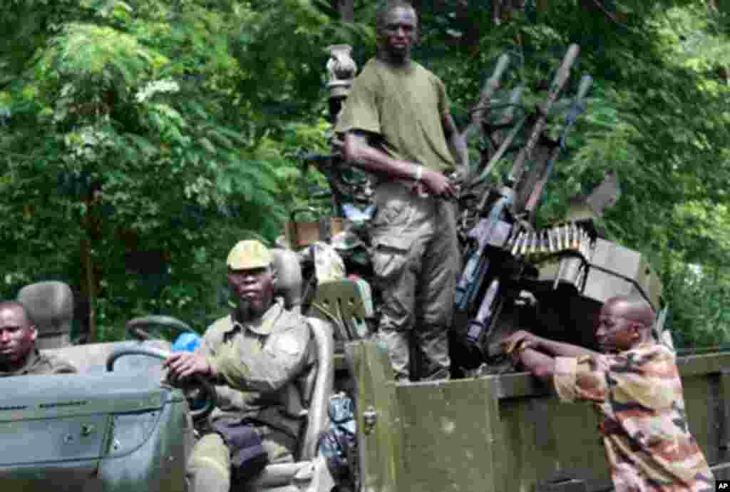Members of Pro-Ouattara forces hold their weapons on March 29, 2011 in Duekoue, in western Ivory Coast